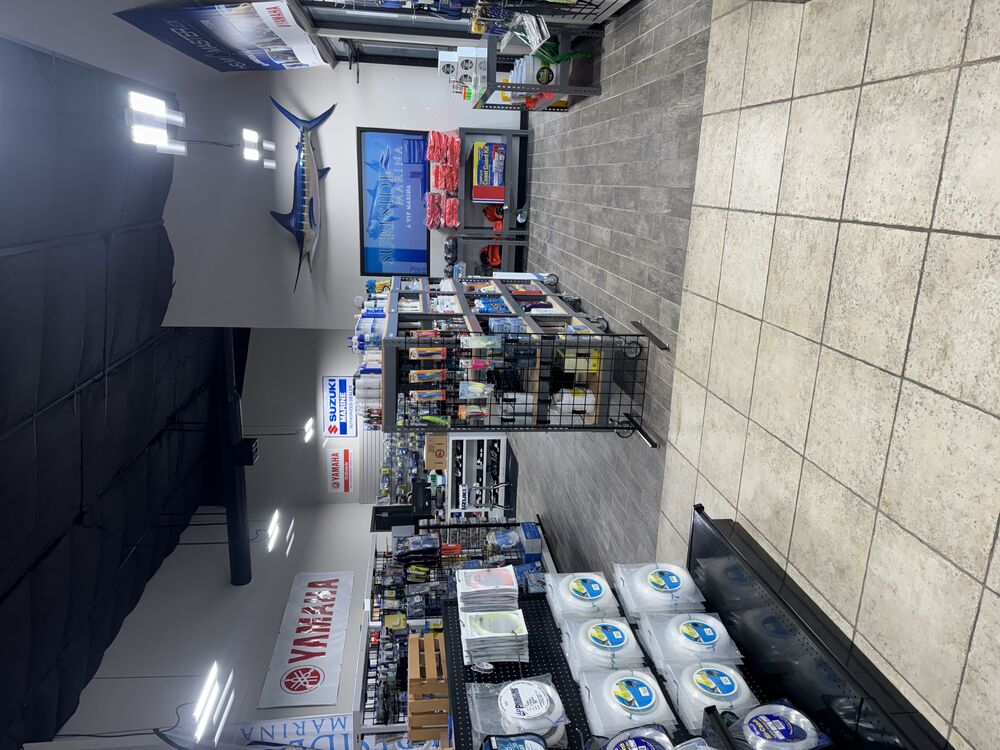 Surfside Marina’s Ship Store interior displaying Yamaha and Suzuki Marine boat parts promotions and fishing supplies