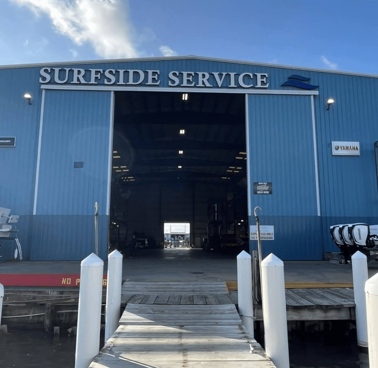 Surfside Marina Service Center A large blue boat repair and storage facility named “Surfside Service.” The barn door is open and shows dry rack boat storage.