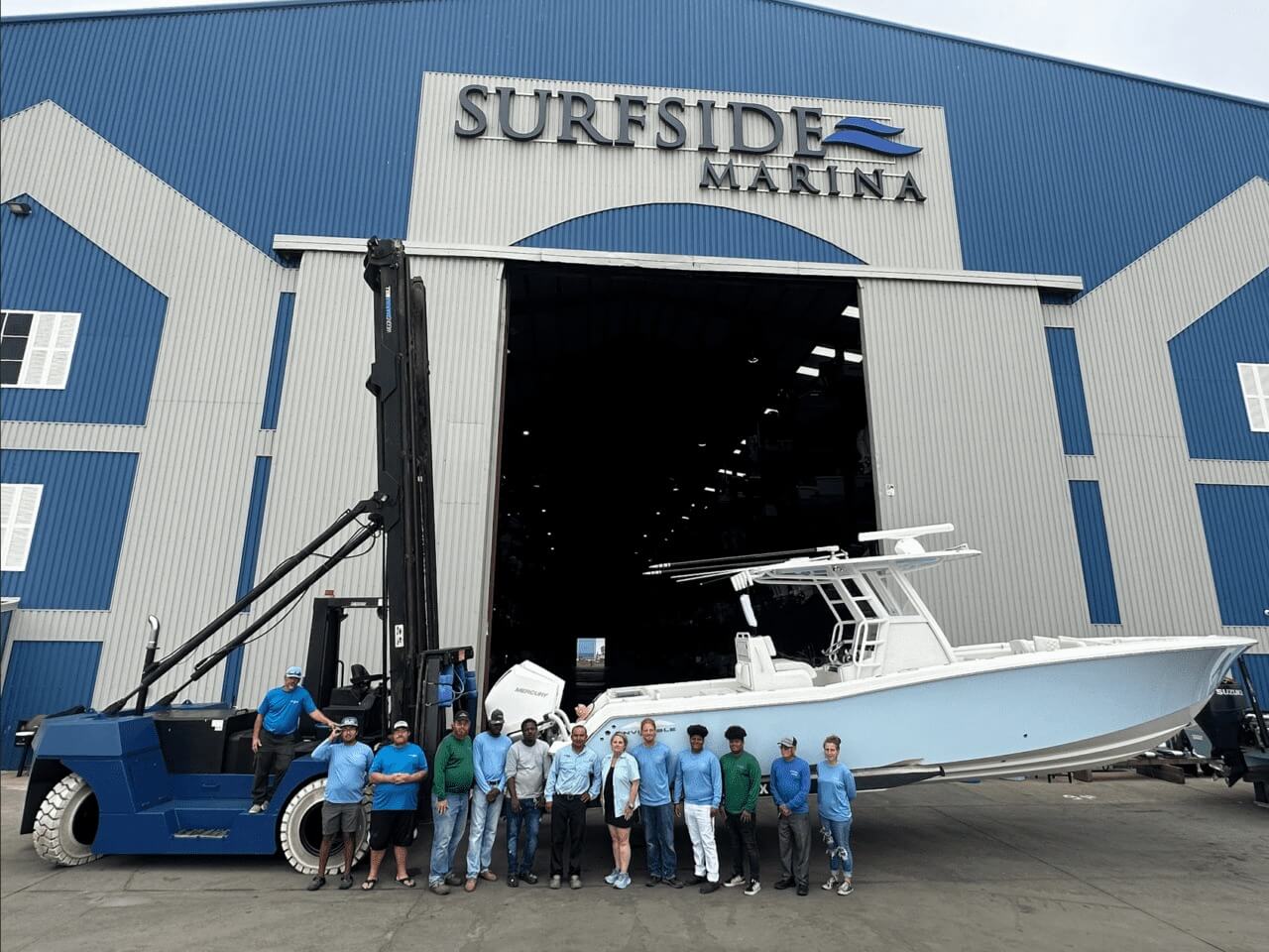 Surfside Marina staff The friendly staff at Surfside Marina in front of a large boat at the entrance of the Surfside Marina barn
